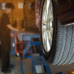 Technician is inflate car tire - car maintenance service transportation safety concept